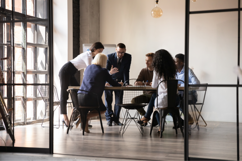 A group of business people working out an issue around a table.