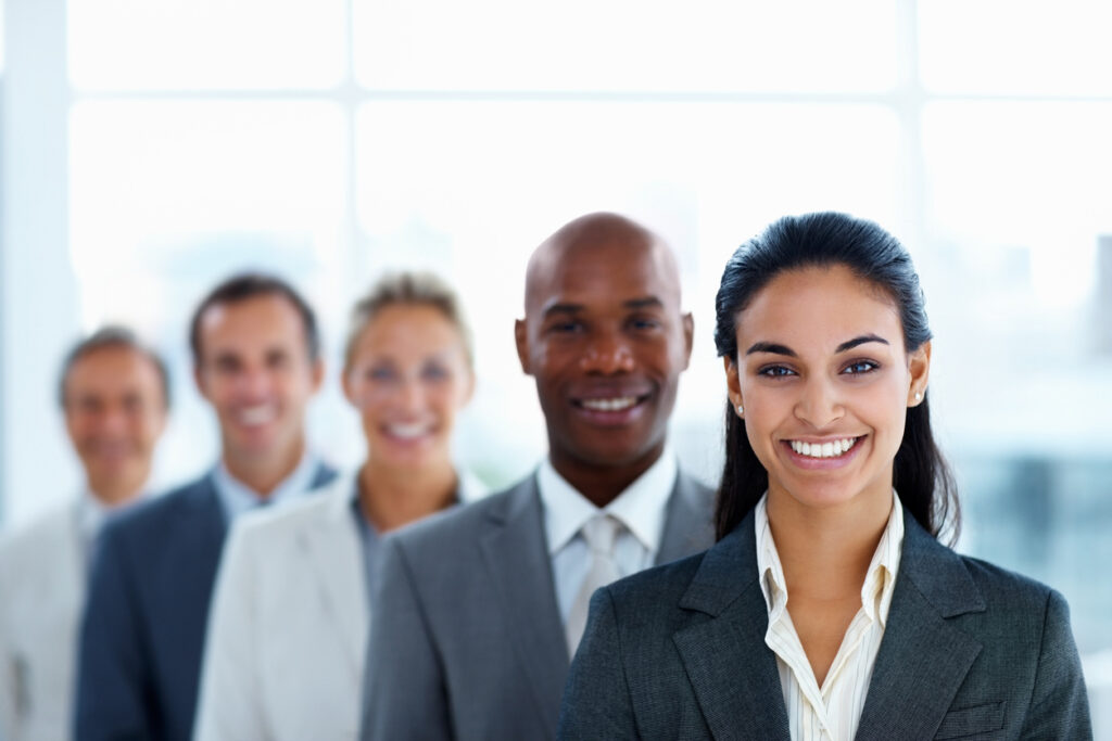 A line of up of diverse people smiling. 