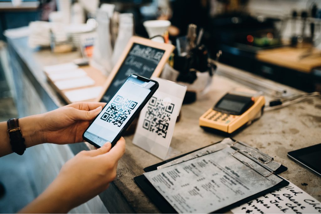 A woman scanning a QR code with an iPhone. 