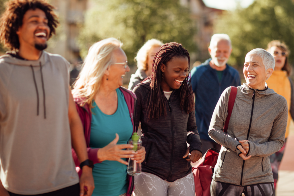 A diverse group of people laughing together. 