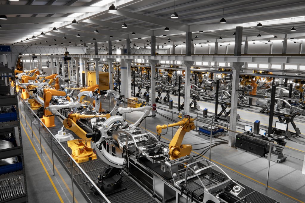 An assembly line of cars being put together in a factory. 